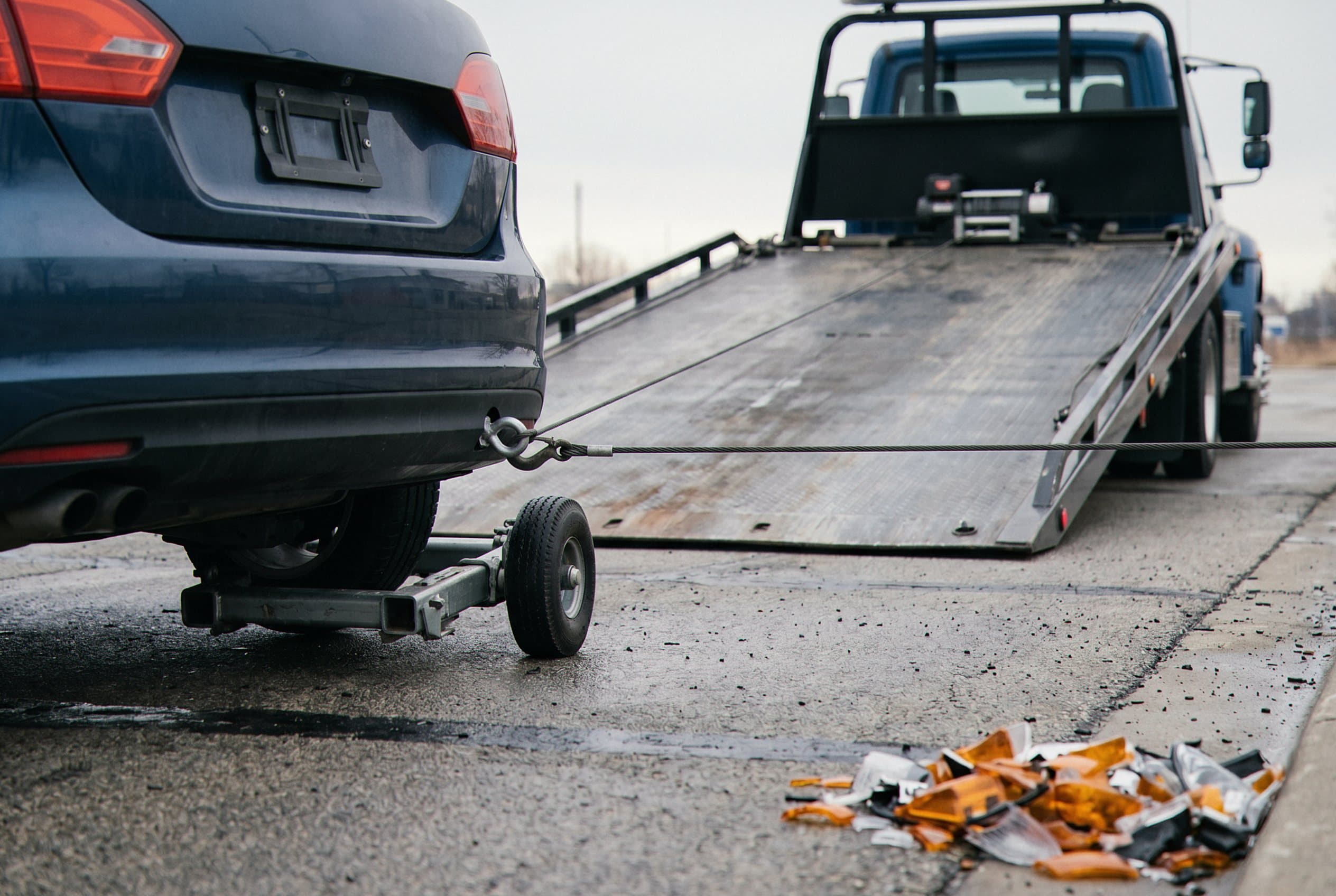 Dolly securing wrecked vehicle
