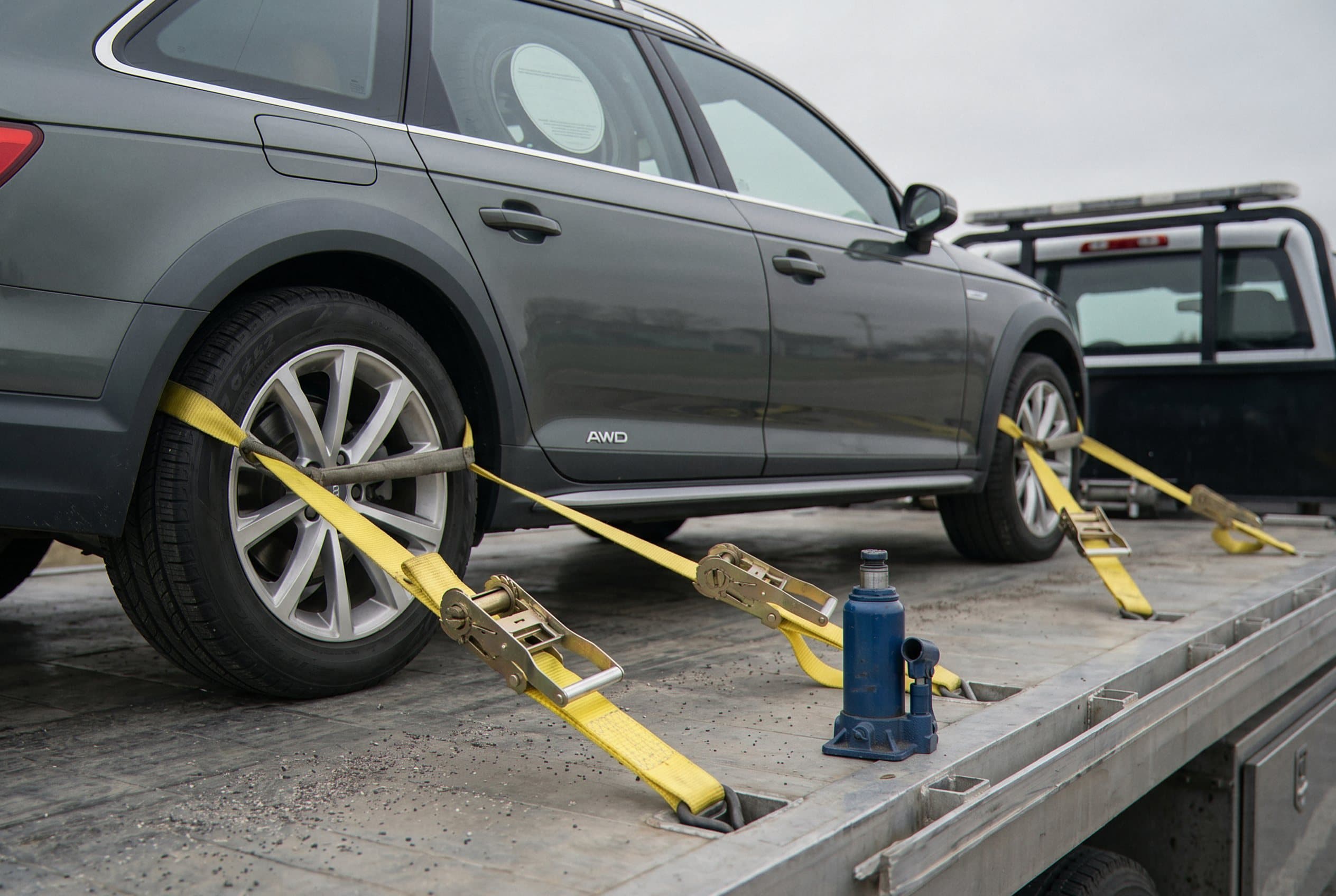 Winch cable securing sedan flatbed
