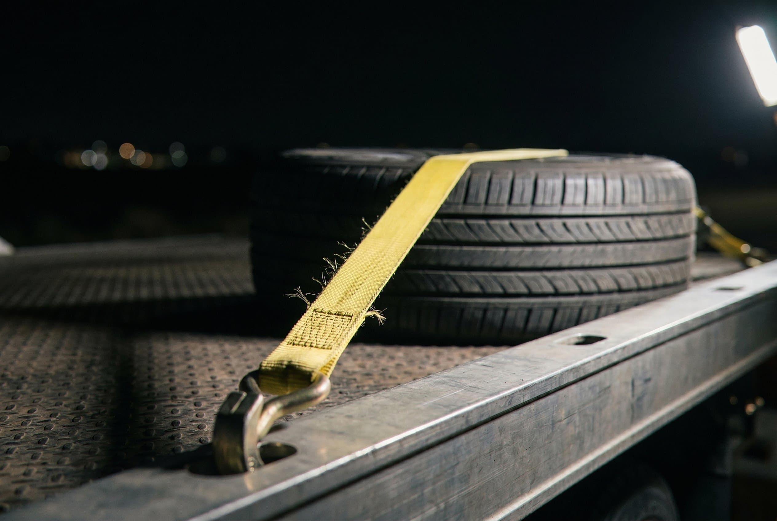 Wheel strap ratchet securing tire