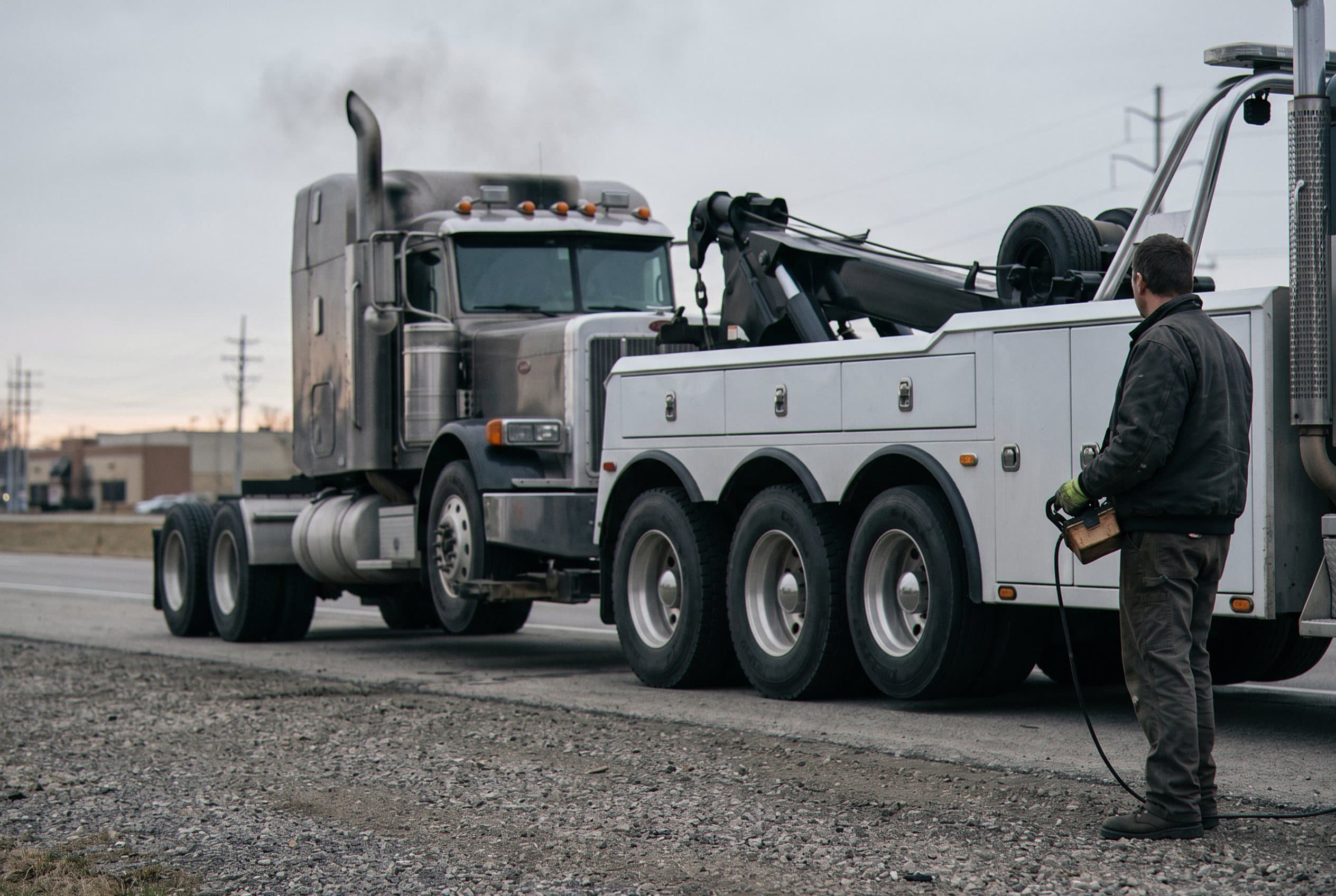 Wrecker boom lifting heavy truck