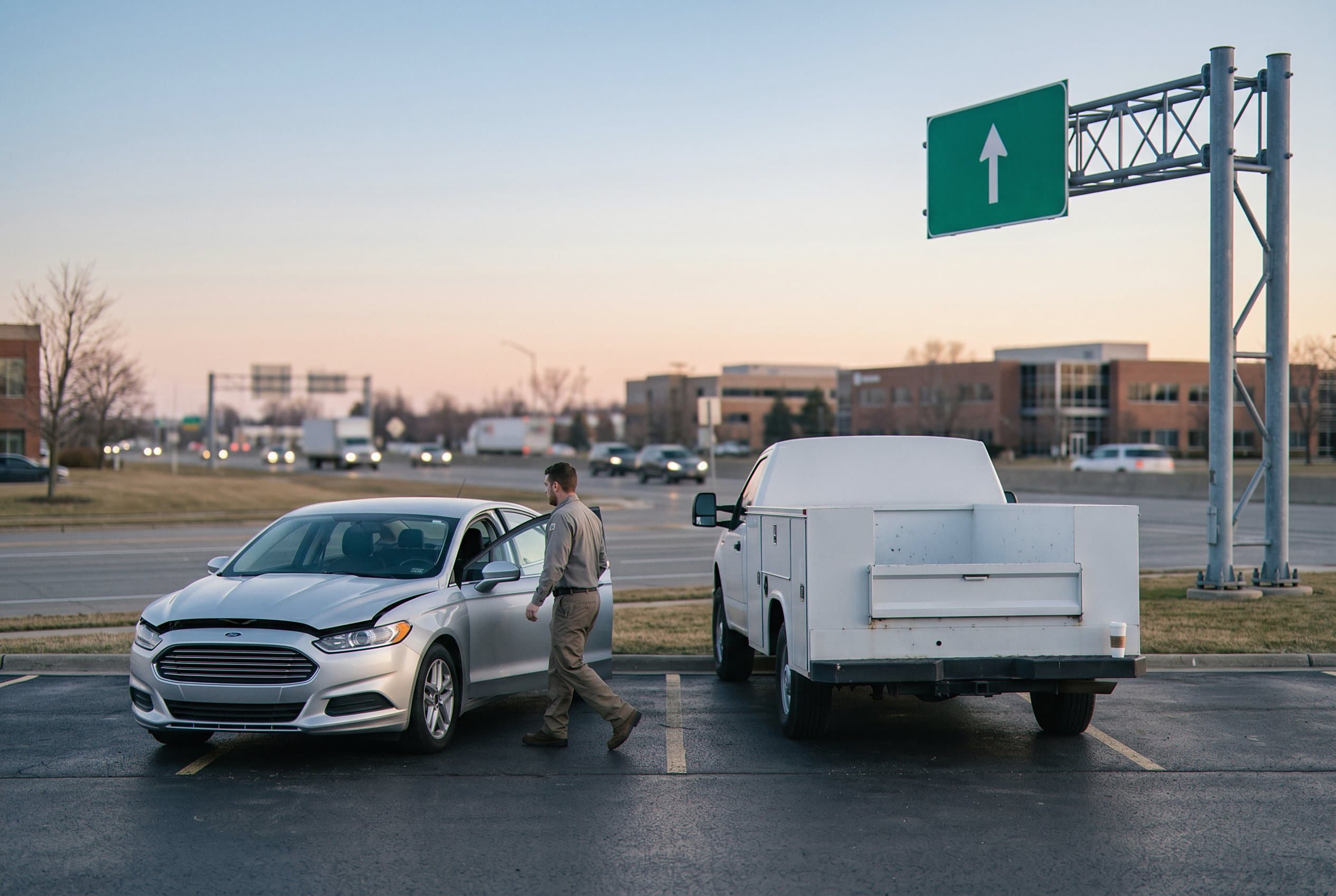 Technician jump starting vehicle parking